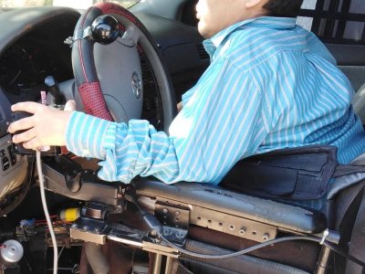 Conductor en silla de ruedas controlando un joystick